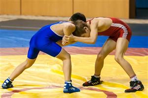 Boys grappling on wrestling mat