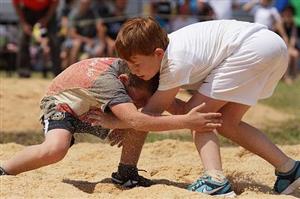 Boys wrestling on the beach